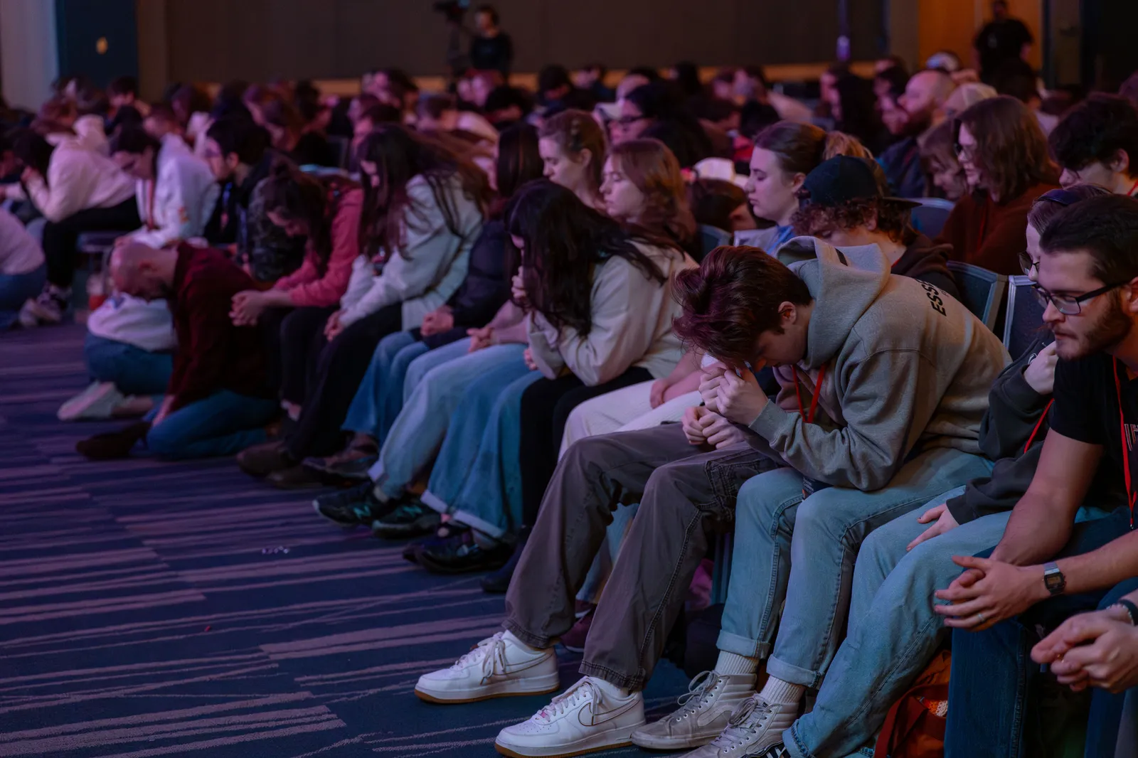 Students praying together at Resonate Conference